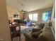 Cozy living room with a ceiling fan, fireplace, and a comfortable sofa, perfect for relaxation and gatherings at 5404 Drum Inlet Pl, Raleigh, NC 27610