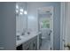 Powder blue bathroom with marble floors, white vanity, and brushed nickel fixtures at 5632 Falkirk Dr, Durham, NC 27712