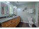 Well lit bathroom with double vanity, dark wood floors, and a neutral color palette at 5632 Falkirk Dr, Durham, NC 27712