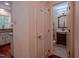 Hallway view into a traditional bathroom with vintage-style vanity and a warm aesthetic at 5632 Falkirk Dr, Durham, NC 27712