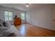 Bright bedroom with hardwood floors, natural light from two windows, and a cozy daybed at 5632 Falkirk Dr, Durham, NC 27712