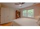 Bedroom with hardwood floors, ceiling fan, and built-in armoire at 5632 Falkirk Dr, Durham, NC 27712