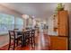 Open dining area with hardwood floors, neutral walls, and view of the kitchen at 5632 Falkirk Dr, Durham, NC 27712