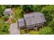 Aerial view showcases the home's exterior, driveway, mature landscaping, and detached garage at 5632 Falkirk Dr, Durham, NC 27712