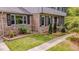 Charming brick home featuring black shutters, well-maintained landscaping, and a welcoming front porch at 5632 Falkirk Dr, Durham, NC 27712
