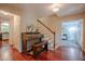 Foyer with hardwood floors, piano, staircase and hallway with views to the kitchen at 5632 Falkirk Dr, Durham, NC 27712
