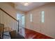 Bright foyer featuring hardwood floors, a staircase, and a view to the living area at 5632 Falkirk Dr, Durham, NC 27712