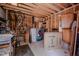 Cluttered unfinished garage with exposed beams, shelving, and items stored against the walls at 5632 Falkirk Dr, Durham, NC 27712