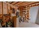 An unfinished garage featuring exposed beams, shelving, and stored items against the walls at 5632 Falkirk Dr, Durham, NC 27712