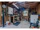 A cluttered garage with workbench, shelving, and various tools and equipment at 5632 Falkirk Dr, Durham, NC 27712