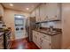 Cozy kitchen featuring stainless steel appliances, granite countertops, and cherry hardwood flooring at 5632 Falkirk Dr, Durham, NC 27712