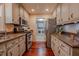 Well-equipped kitchen with stainless steel appliances, granite countertops, and cherry hardwood floors at 5632 Falkirk Dr, Durham, NC 27712