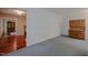 View of the carpeted living room with a hardwood cabinet and doorway to another room at 5632 Falkirk Dr, Durham, NC 27712
