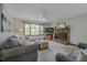 Inviting living room with a brick fireplace, ceiling fan, and large window at 5632 Falkirk Dr, Durham, NC 27712