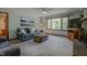 Inviting living room with a brick fireplace, ceiling fan, and large window at 5632 Falkirk Dr, Durham, NC 27712