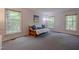 Inviting living room bathed in natural light from multiple windows, complete with comfortable futon at 5632 Falkirk Dr, Durham, NC 27712