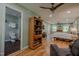 Hardwood floors and neutral walls fill this spacious main bedroom featuring a ceiling fan at 5632 Falkirk Dr, Durham, NC 27712