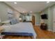 Large main bedroom includes hardwood floors, a ceiling fan, and a wall-mounted tv at 5632 Falkirk Dr, Durham, NC 27712