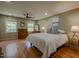 Spacious bedroom with hardwood floors, ceiling fan, and bright natural light from two windows at 5632 Falkirk Dr, Durham, NC 27712