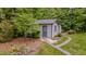 Charming outbuilding with a neutral color scheme, surrounded by lush landscaping and greenery at 5632 Falkirk Dr, Durham, NC 27712
