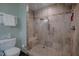 Modern shower stall with tile surround, mosaic accents, bench, and seamless glass door at 5632 Falkirk Dr, Durham, NC 27712