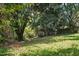 Spacious backyard featuring mature trees and shaded area at 5805 Farm Gate Rd, Raleigh, NC 27606