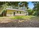 Backyard view of home with a siding exterior, door, and verdant green grass at 5805 Farm Gate Rd, Raleigh, NC 27606