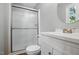 Modern bathroom with white vanity, enclosed shower, and neutral tones at 5805 Farm Gate Rd, Raleigh, NC 27606