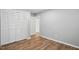 Bedroom featuring hardwood floors and a spacious closet at 5805 Farm Gate Rd, Raleigh, NC 27606