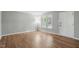 Bright bedroom with hardwood floors, a large window, and ample natural light at 5805 Farm Gate Rd, Raleigh, NC 27606