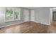 Inviting bedroom with hardwood flooring, a window, and a neutral color palette at 5805 Farm Gate Rd, Raleigh, NC 27606