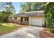 Traditional one-story house features a brick accent and a convenient attached garage at 5805 Farm Gate Rd, Raleigh, NC 27606