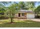 Charming single-story home with brick accents, well-manicured lawn, and an attached garage at 5805 Farm Gate Rd, Raleigh, NC 27606