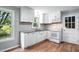 Bright kitchen featuring white cabinets, granite counters, and stainless steel appliances at 5805 Farm Gate Rd, Raleigh, NC 27606