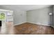 Open living area with sleek hardwood floors and easy access to the kitchen at 5805 Farm Gate Rd, Raleigh, NC 27606