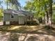 Spacious backyard with a wooden deck, surrounded by lush greenery and mature trees, creating a private outdoor retreat at 6005 Antigua, Knightdale, NC 27545