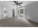 Spacious bedroom with plush carpet, ceiling fan, and large window with outdoor view at 6005 Antigua, Knightdale, NC 27545