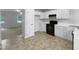 Bright kitchen with white cabinets and black appliances offers a functional and clean space at 6005 Antigua, Knightdale, NC 27545