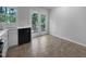 Eat-in kitchen features stainless steel sink, black dishwasher, and access to deck at 6005 Antigua, Knightdale, NC 27545