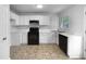 Efficient kitchen with white cabinets, black appliances, and ample counter space for all culinary creations at 6005 Antigua, Knightdale, NC 27545