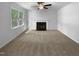A bright living room features a fireplace and large windows, providing natural light and a cozy atmosphere at 6005 Antigua, Knightdale, NC 27545