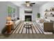 Bright, staged living room with fireplace, ceiling fan and plush white furniture, offering a cozy and inviting space at 6005 Antigua, Knightdale, NC 27545