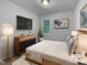 Comfortable main bedroom with a cozy bed, stylish furniture, and a large TV, ideal for relaxation and entertainment at 6005 Antigua, Knightdale, NC 27545
