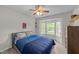 Comfortable bedroom with a bay window, ceiling fan, neutral color scheme, and warm lighting at 6204 Silver Spring Ct, Willow Springs, NC 27592