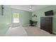 Cozy bedroom features light green walls, carpet flooring, and a ceiling fan at 6204 Silver Spring Ct, Willow Springs, NC 27592