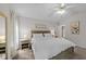 Calm bedroom setting with a cozy bed, ceiling fan, and an entrance to the bathroom at 6204 Silver Spring Ct, Willow Springs, NC 27592
