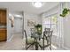 Bright dining area featuring a glass table, seating for four, and natural light at 6204 Silver Spring Ct, Willow Springs, NC 27592