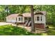 Attractive home with a lush green lawn and inviting entrance with stairs at 6204 Silver Spring Ct, Willow Springs, NC 27592