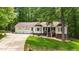 Charming home with a well-manicured lawn, bay windows, and an attached two-car garage at 6204 Silver Spring Ct, Willow Springs, NC 27592