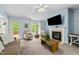 Spacious living room with fireplace, natural light, and access to an outdoor deck at 6204 Silver Spring Ct, Willow Springs, NC 27592
